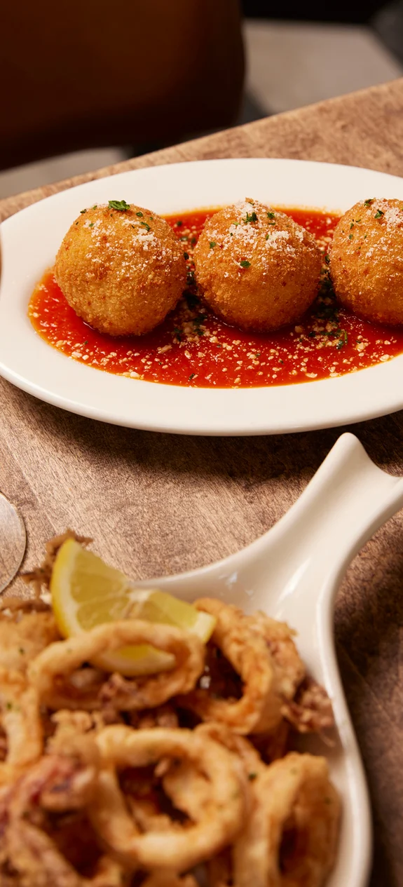 Dish with arancini and red sauce