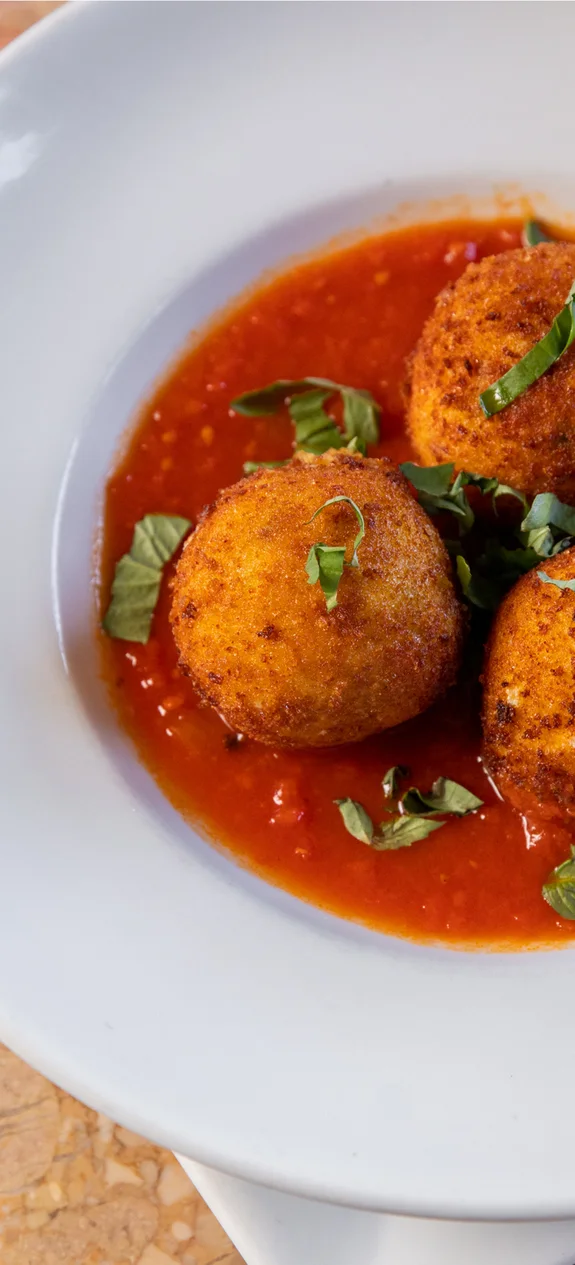 Dish with arancini and red sauce