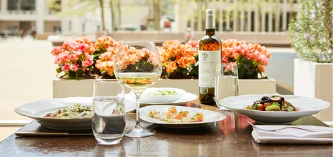 a table with plates of food and wine