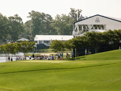 Golf tournament near water and spectators