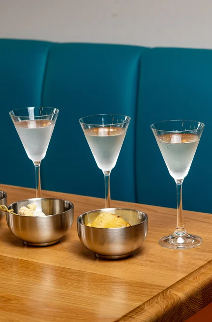 three martini glasses on a table