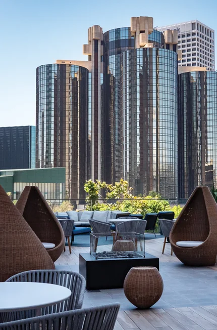 Modern rooftop lounge with city skyline.