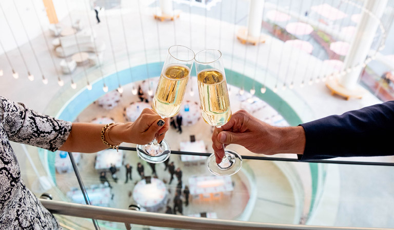 Two people toast with champagne glasses
