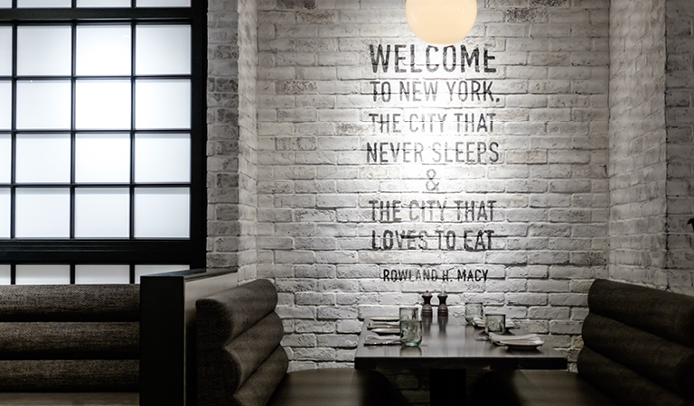 The city that never sleeps & the city that loves to eat - Rowland H. Macy quote inside Rowland's Bar & Grill