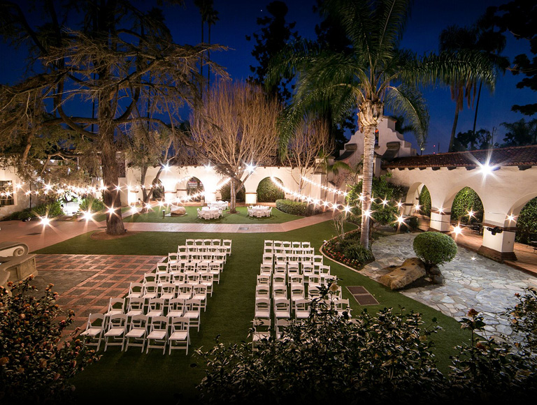 Outdoor wedding venue at night with bright decorative lights